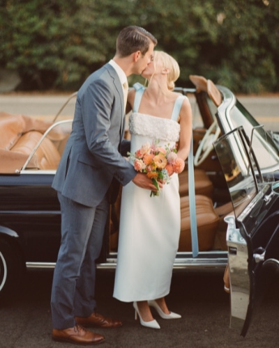 Photo of bride and groom getting into car