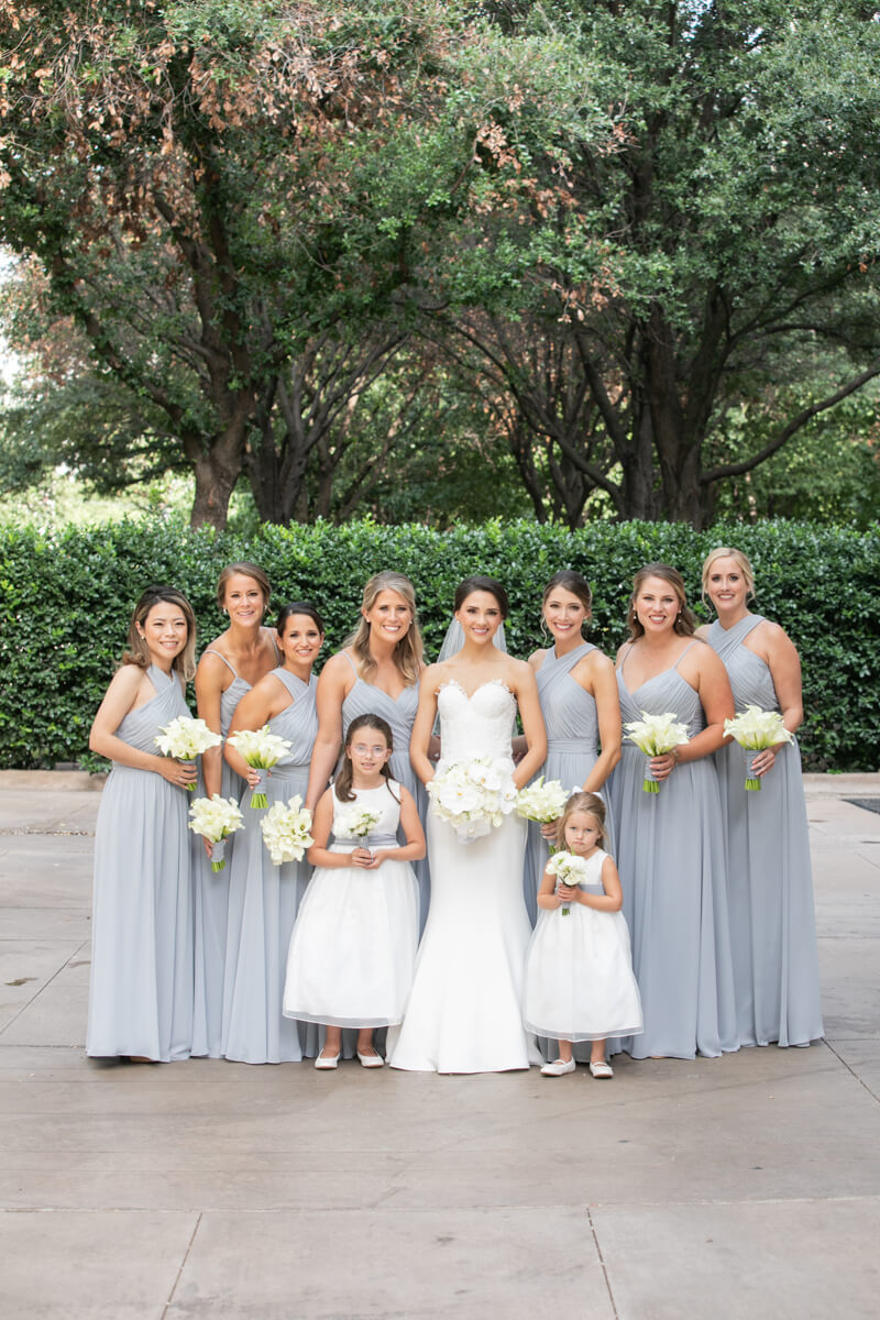 carey posing outdoors with bridesmaids