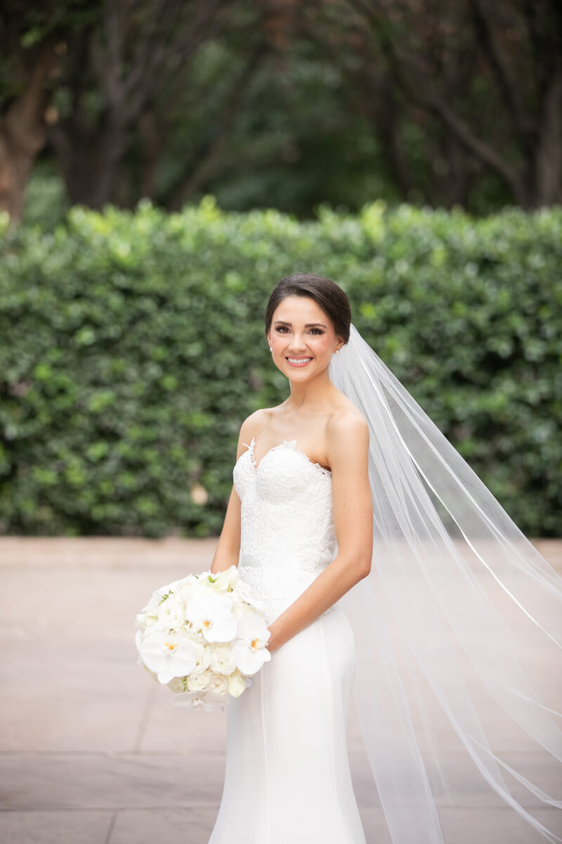 carey posing outdoors alone with veil