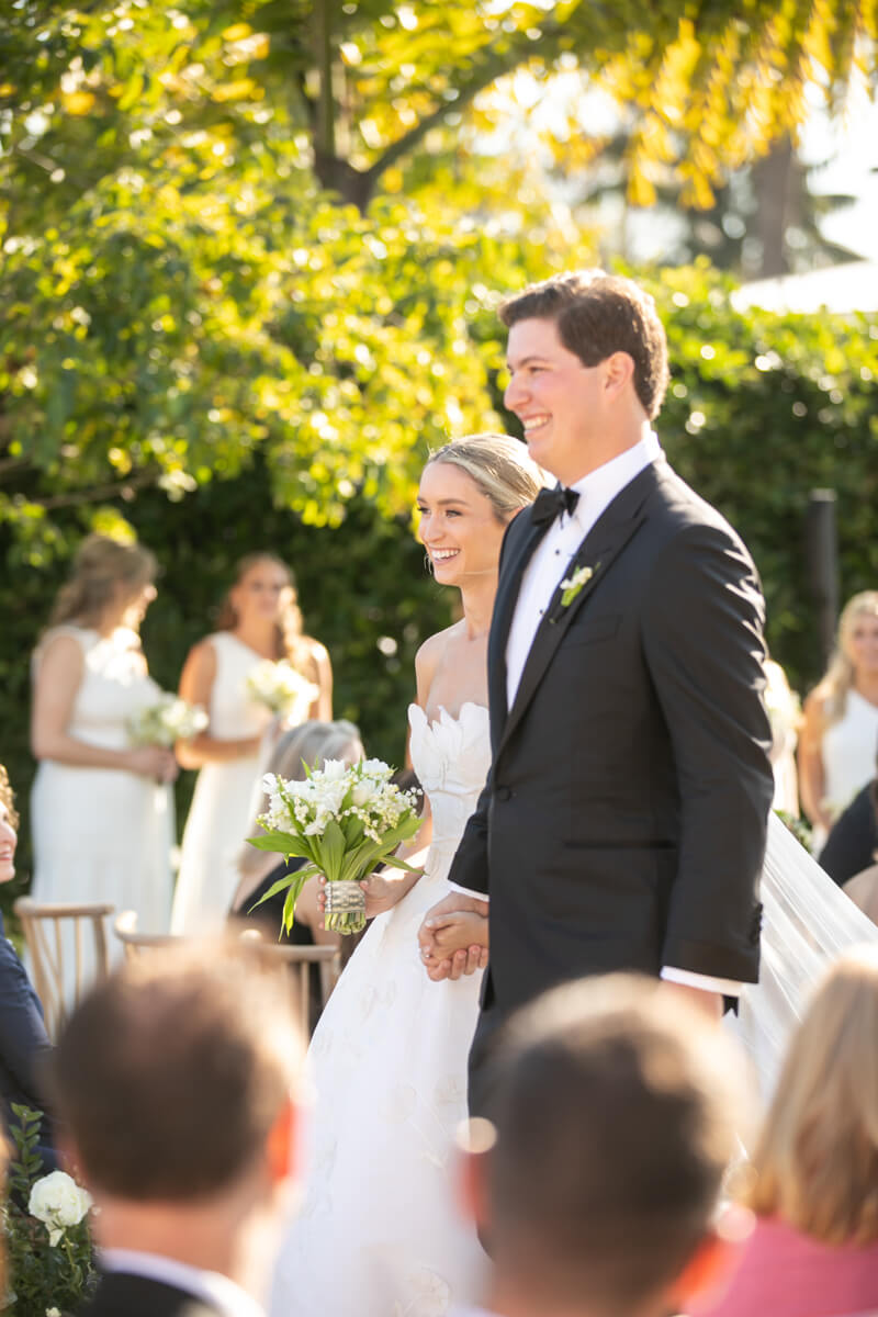 caitlin and geoffrey walking down the aisle