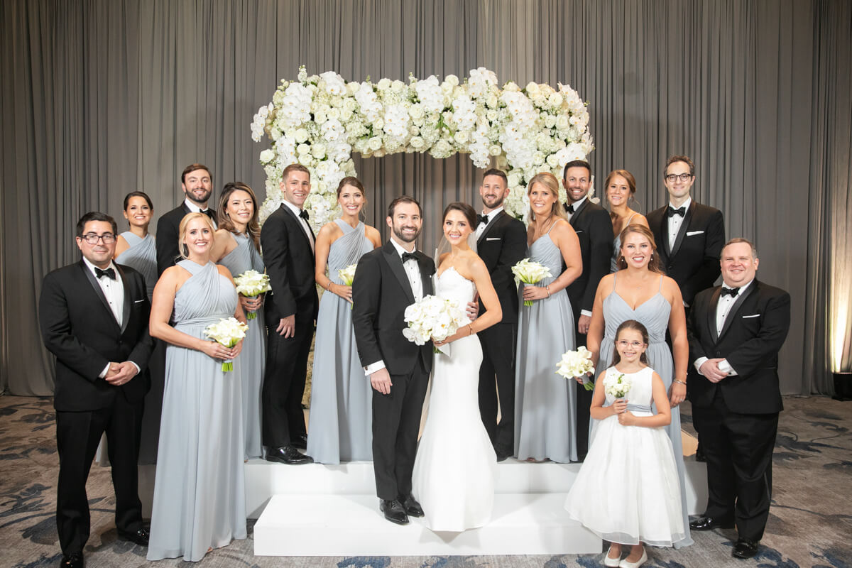 carey and david indoors with entire wedding party