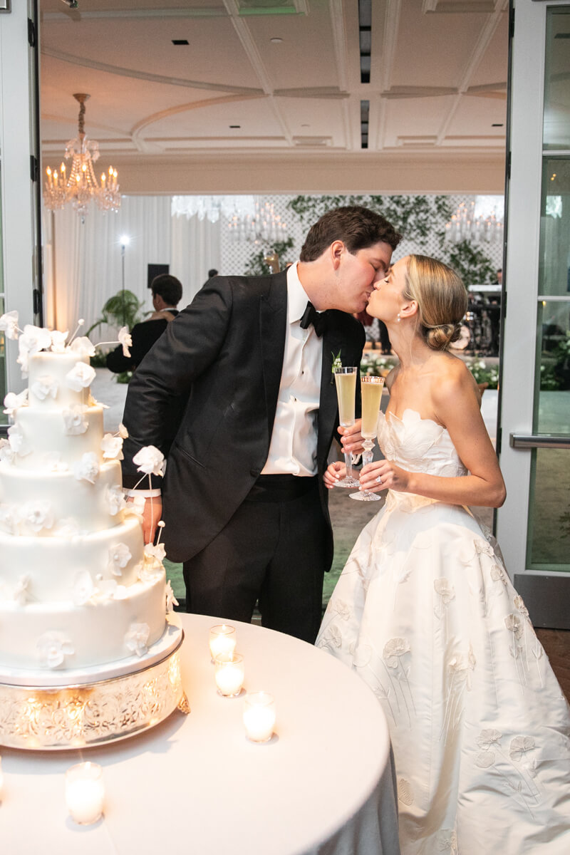 caitlin and geoffrey kissing behind their cake