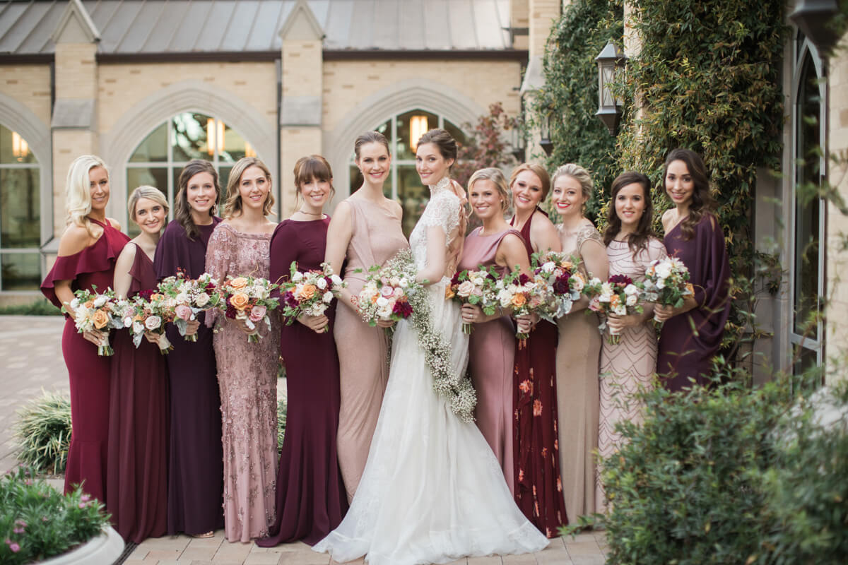 bride and bridesmaids holding flowers