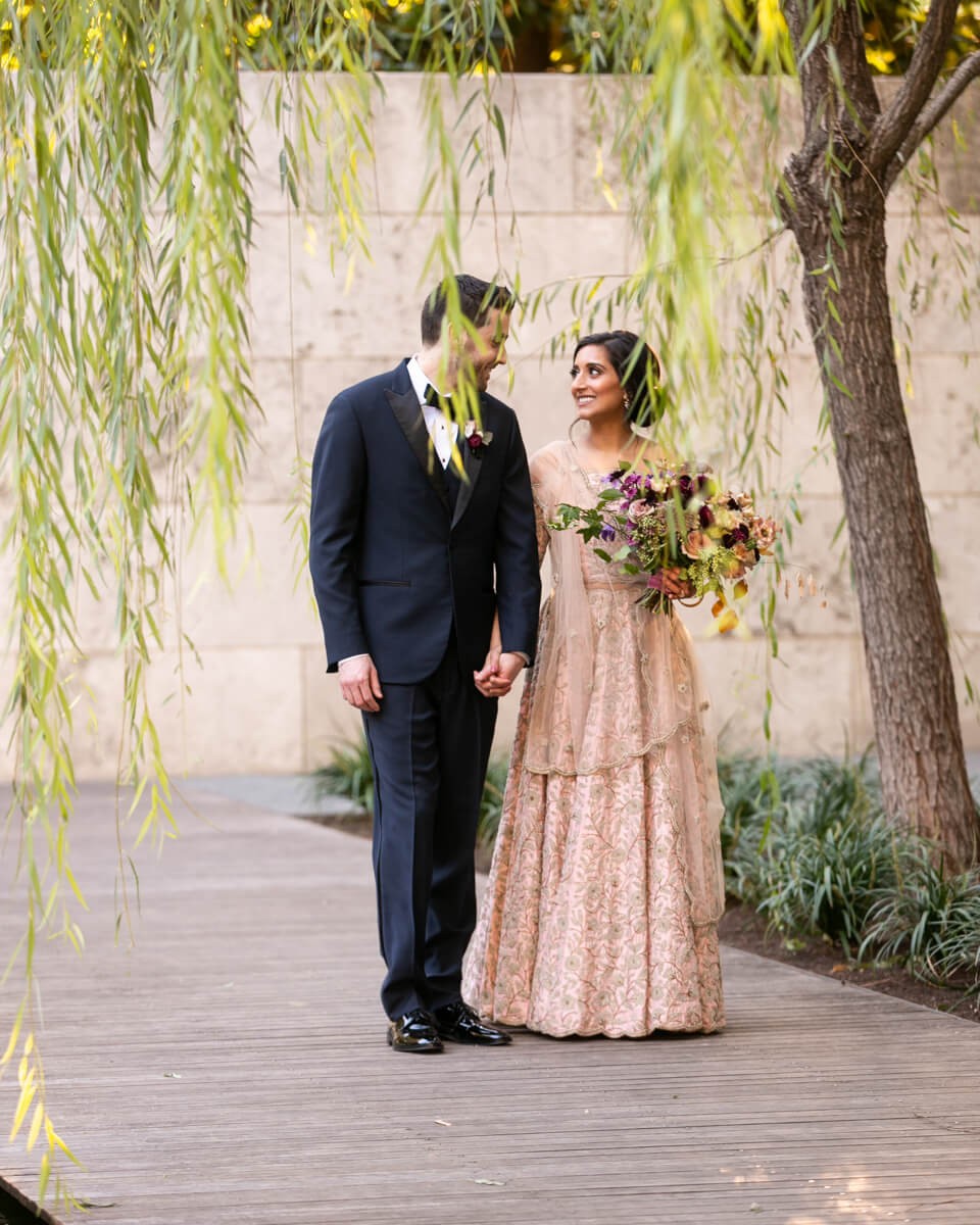 bride and groom walking through the Nasher
