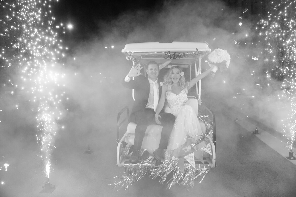 brittney and derek on a golf cart with sparklers
