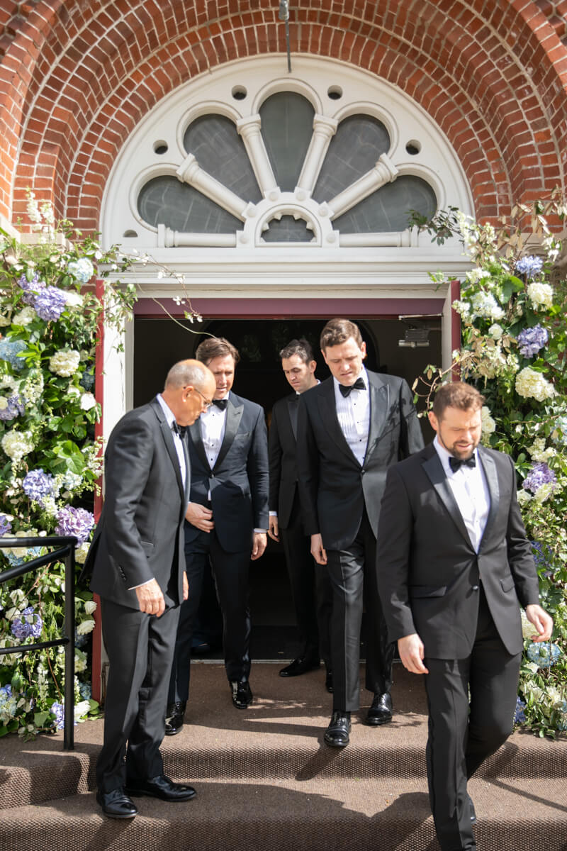 groomsmen walking out of the church