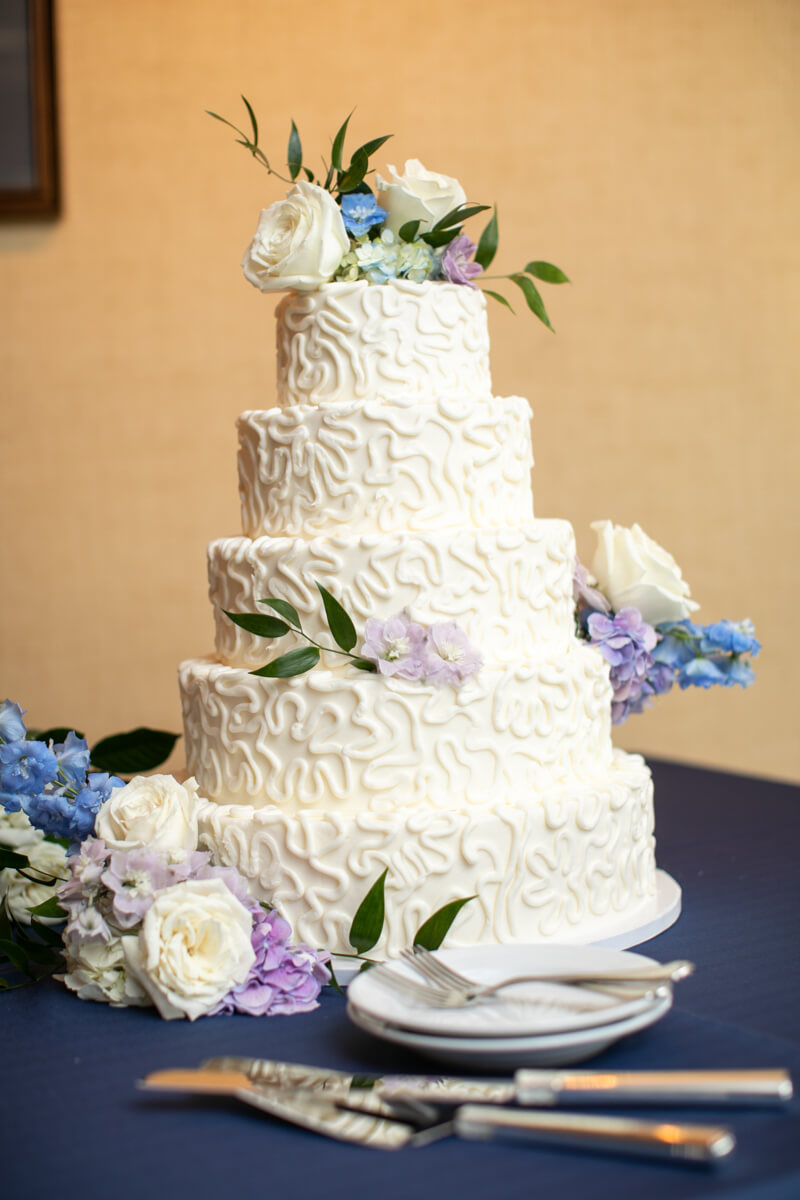 wedding cake with blue flowers