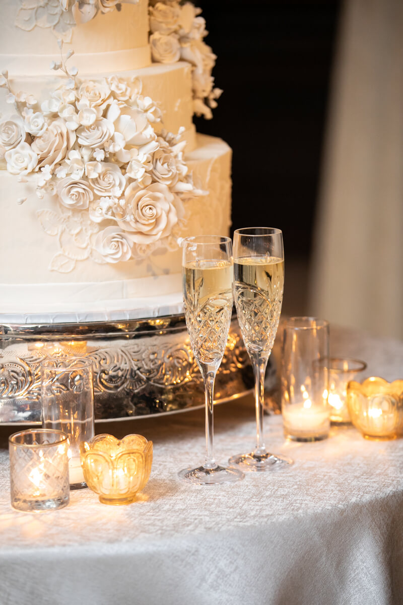 champagne glasses in front of the wedding cake