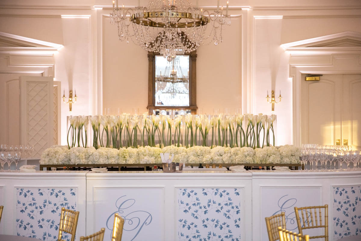 all white floral arrangements on a bar