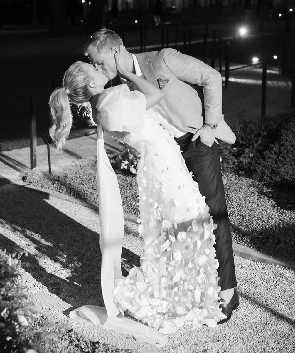Bride and groom kissing at night